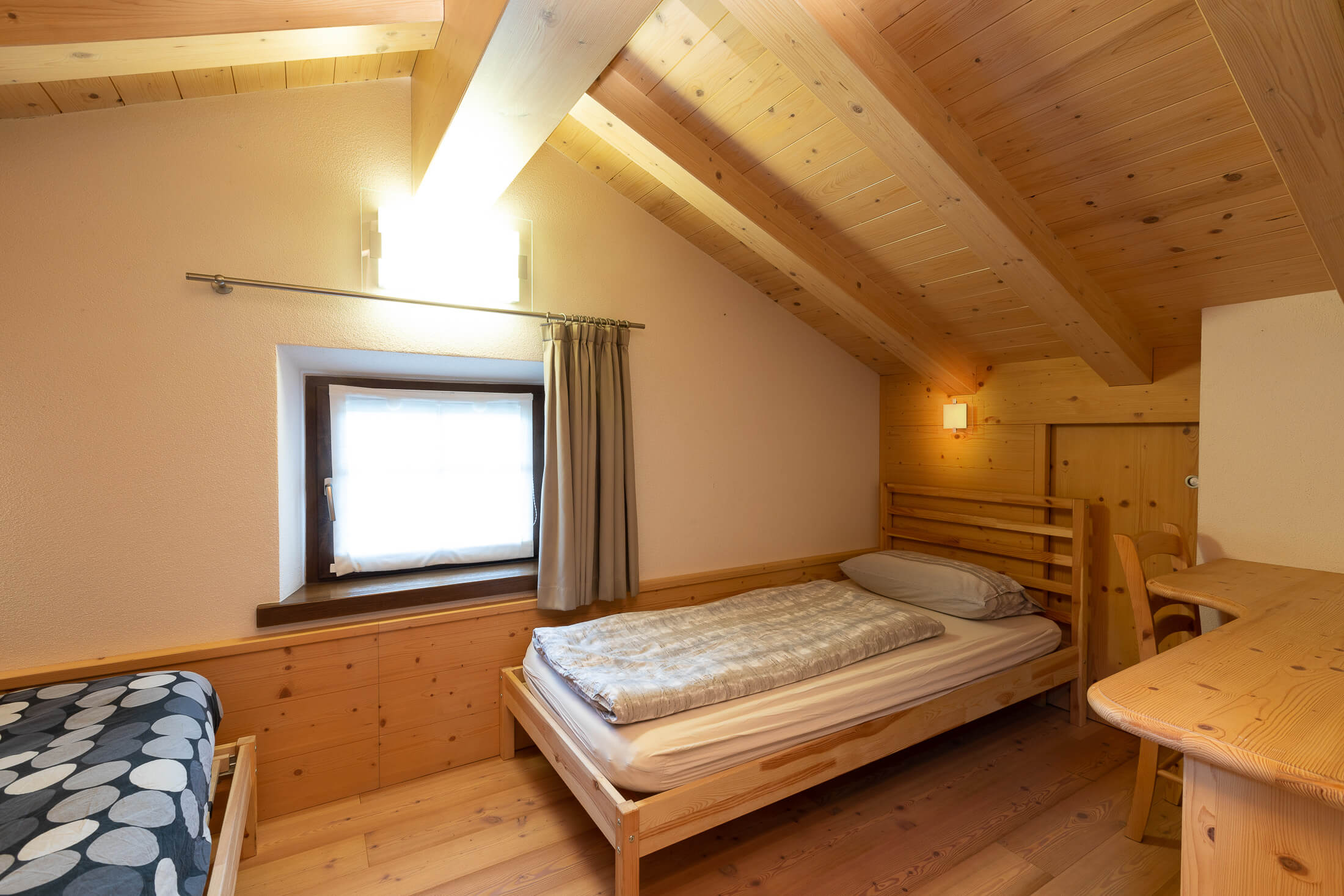 Camera da letto con soffitto in travi di legno